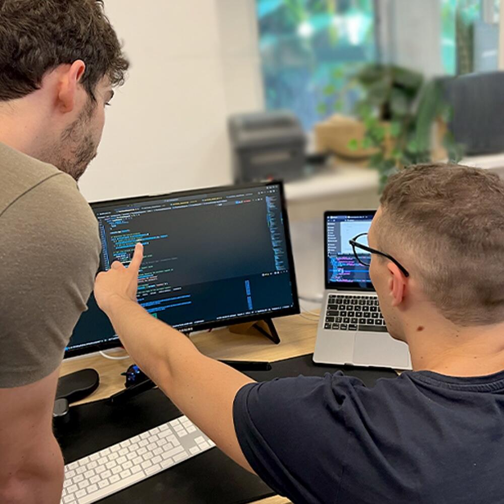 Photo of Tommaso and Samuele making additions to the software according to customer requests