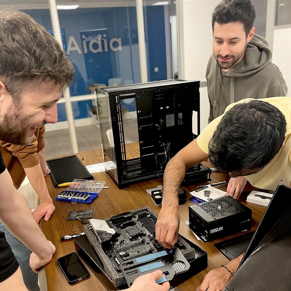 Photo of Luca, Prasanna, and Bernardo assembling a server to run new models